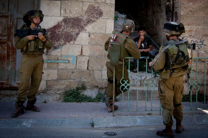 Palestinian man being removed from home. Hebron, Occupied Palestinian Territories